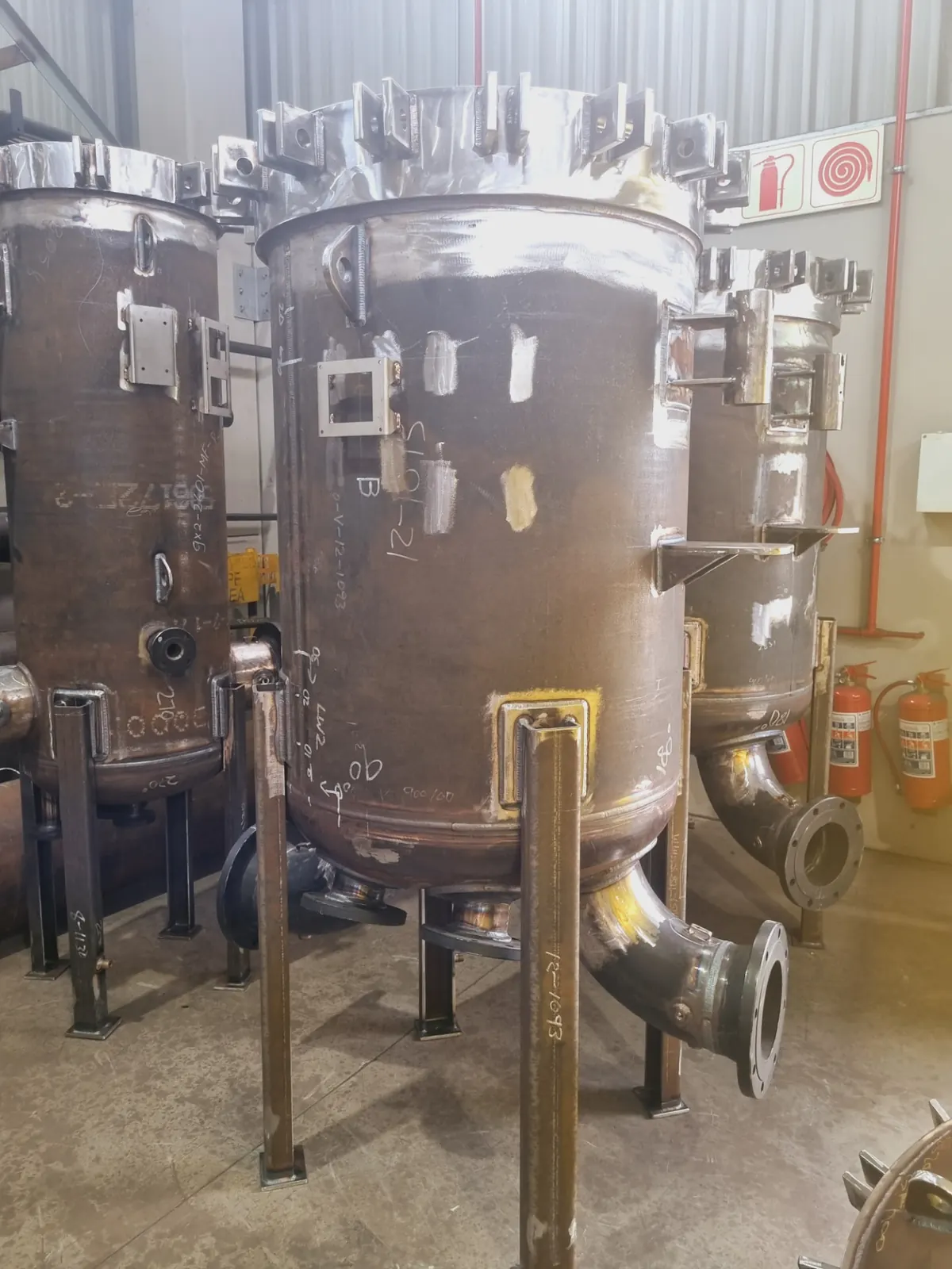 Row of vertical carbon steel pressure vessels awaiting final welding